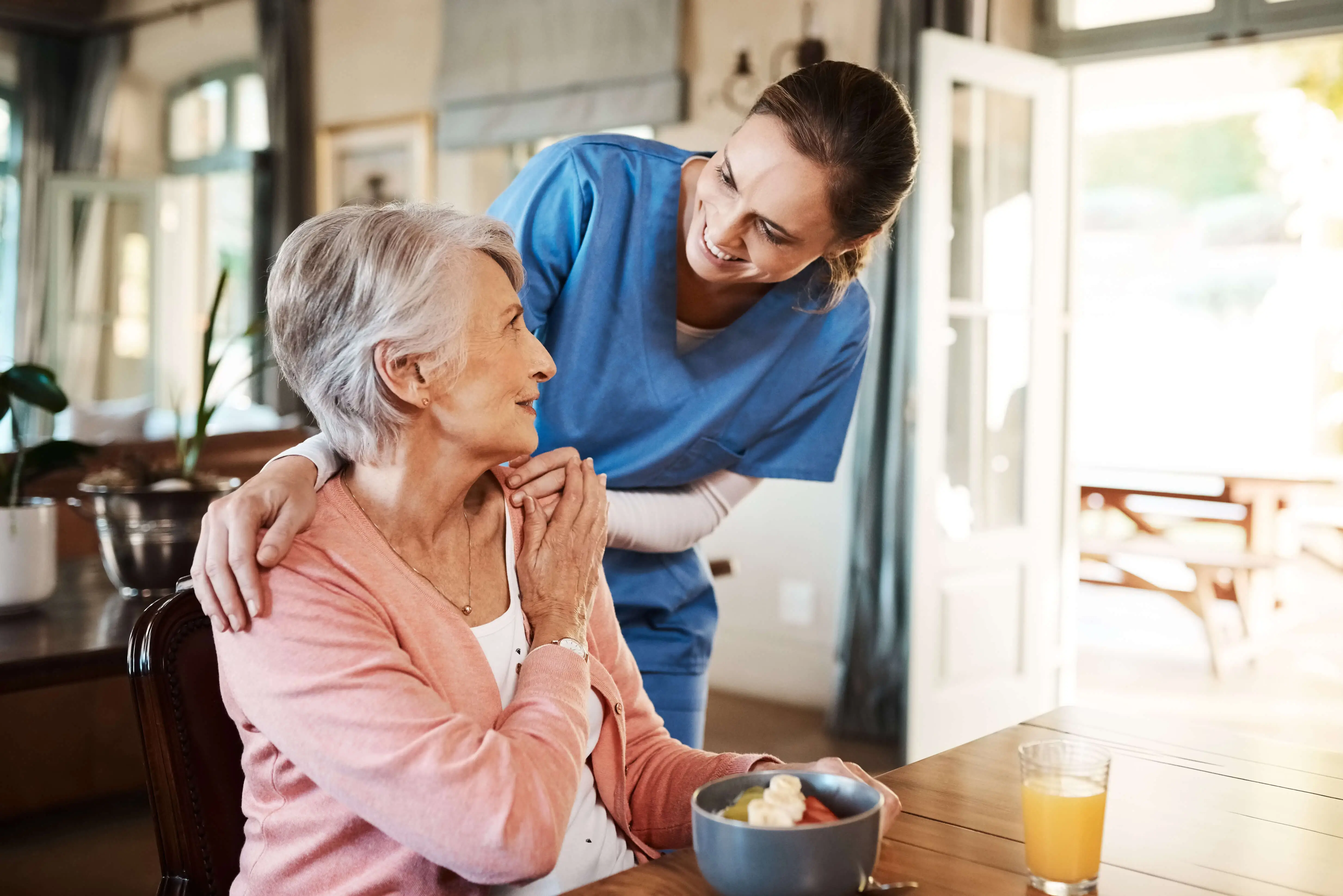 OC HomeCare caregiver assisting senior woman with healthy mealtime support at home in Lake Forest, Orange County, CA