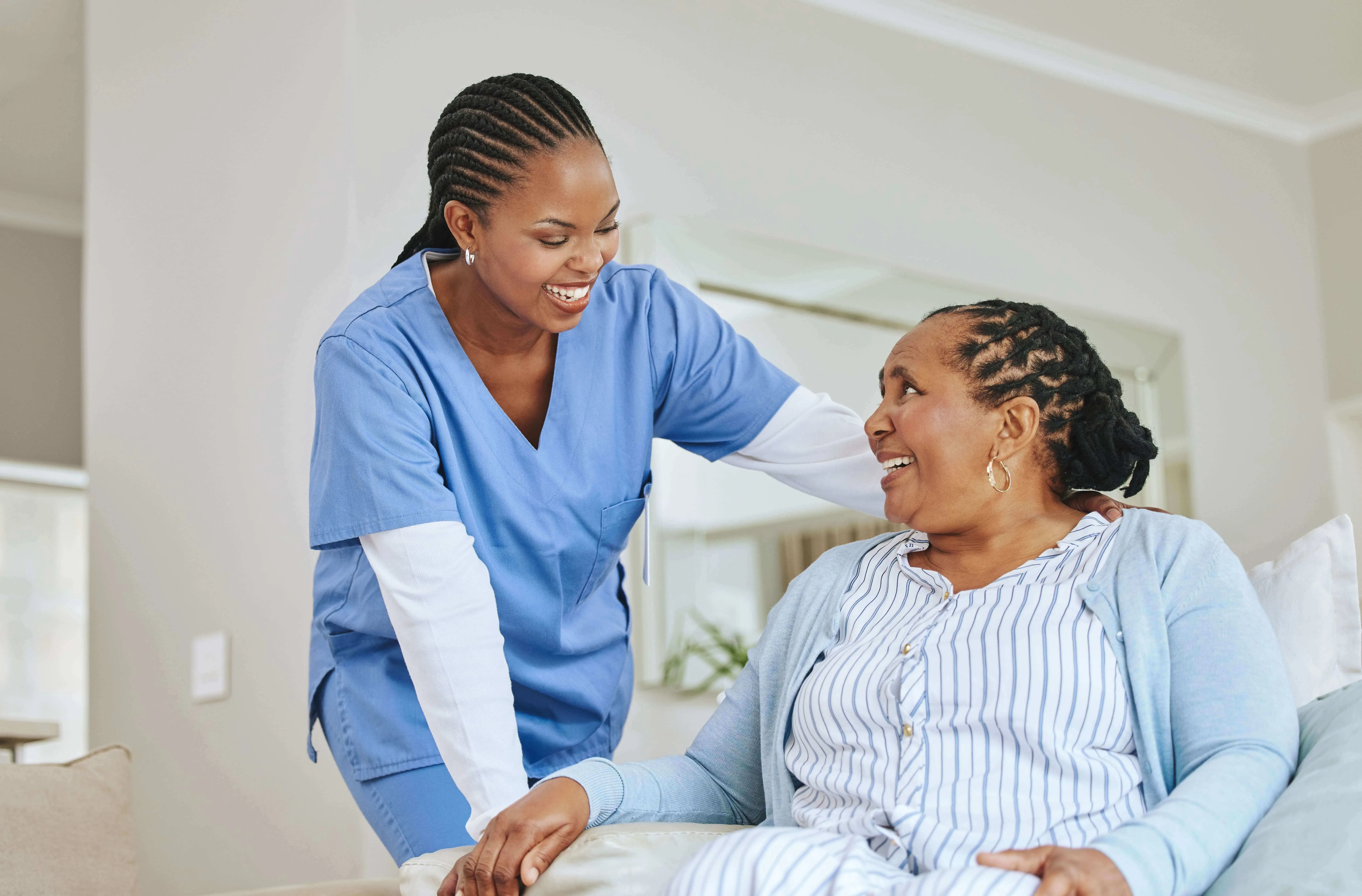 OC HomeCare caregiver providing personalized assisted living support to a smiling senior woman in her Orange County home
