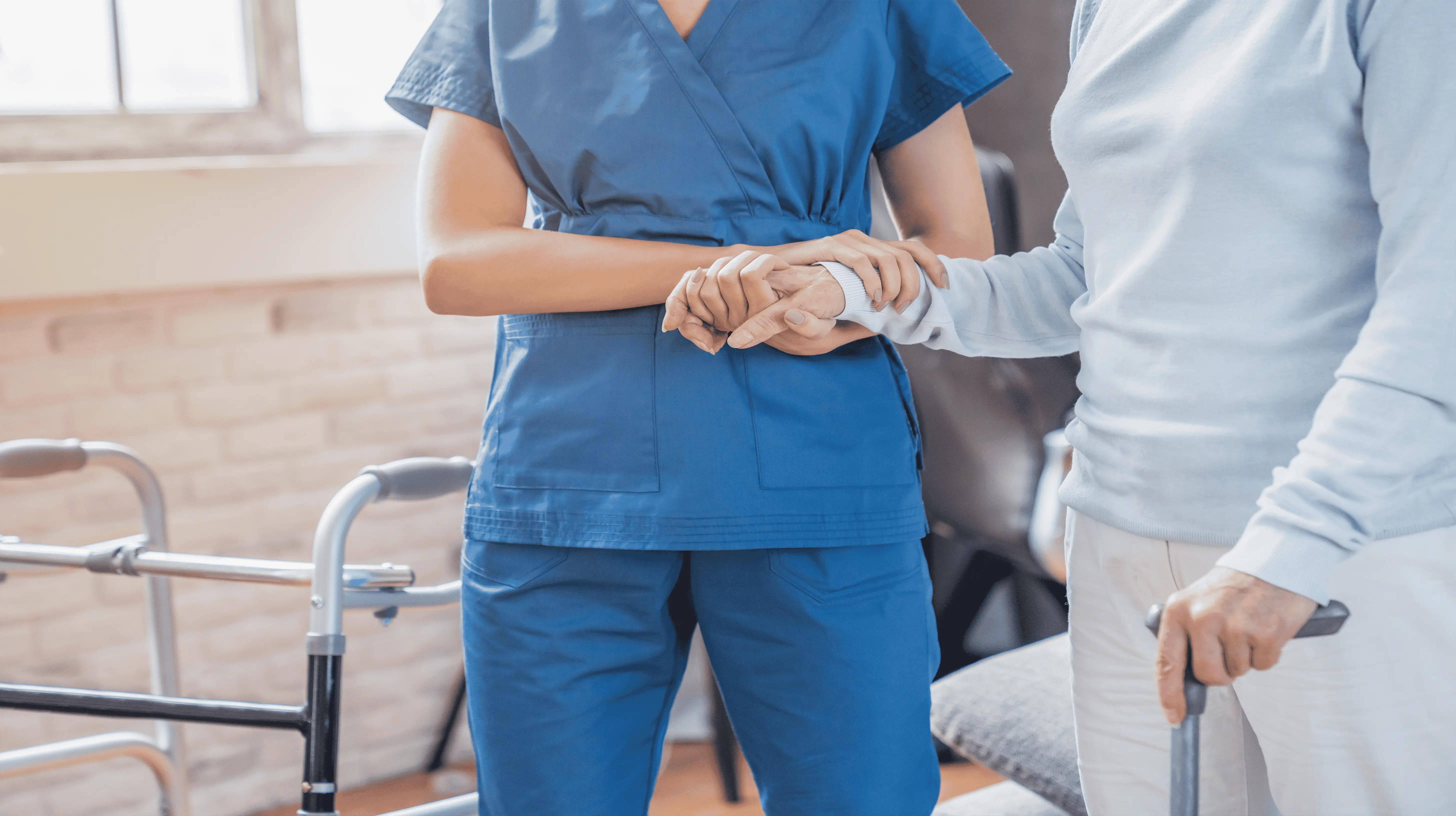 OC HomeCare nurse helping senior client with mobility and personal care in a respectful, supportive Orange County home environment