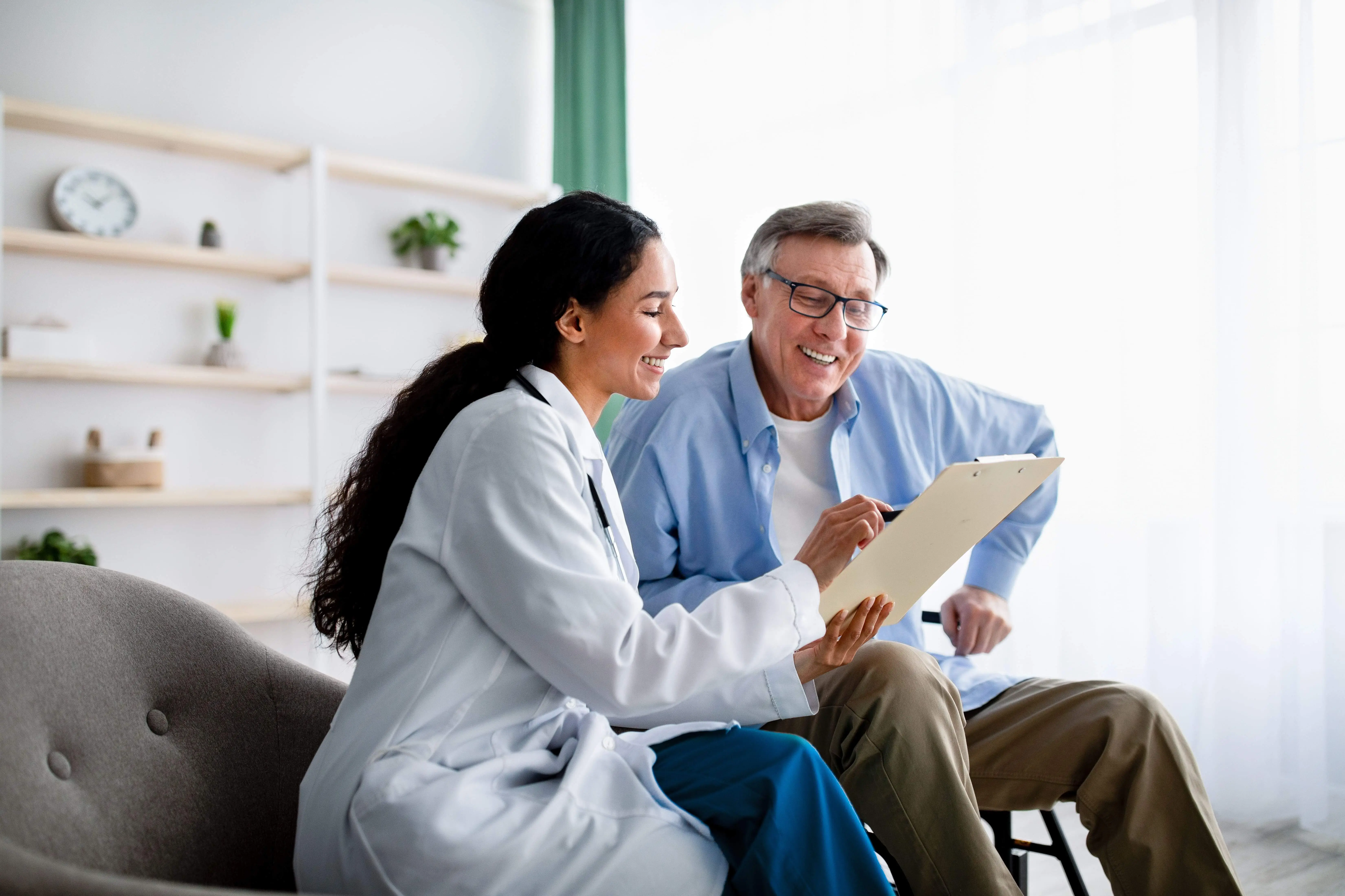 OC HomeCare nurse assisting a senior man with personalized residential care planning and supportive conversation in Orange County