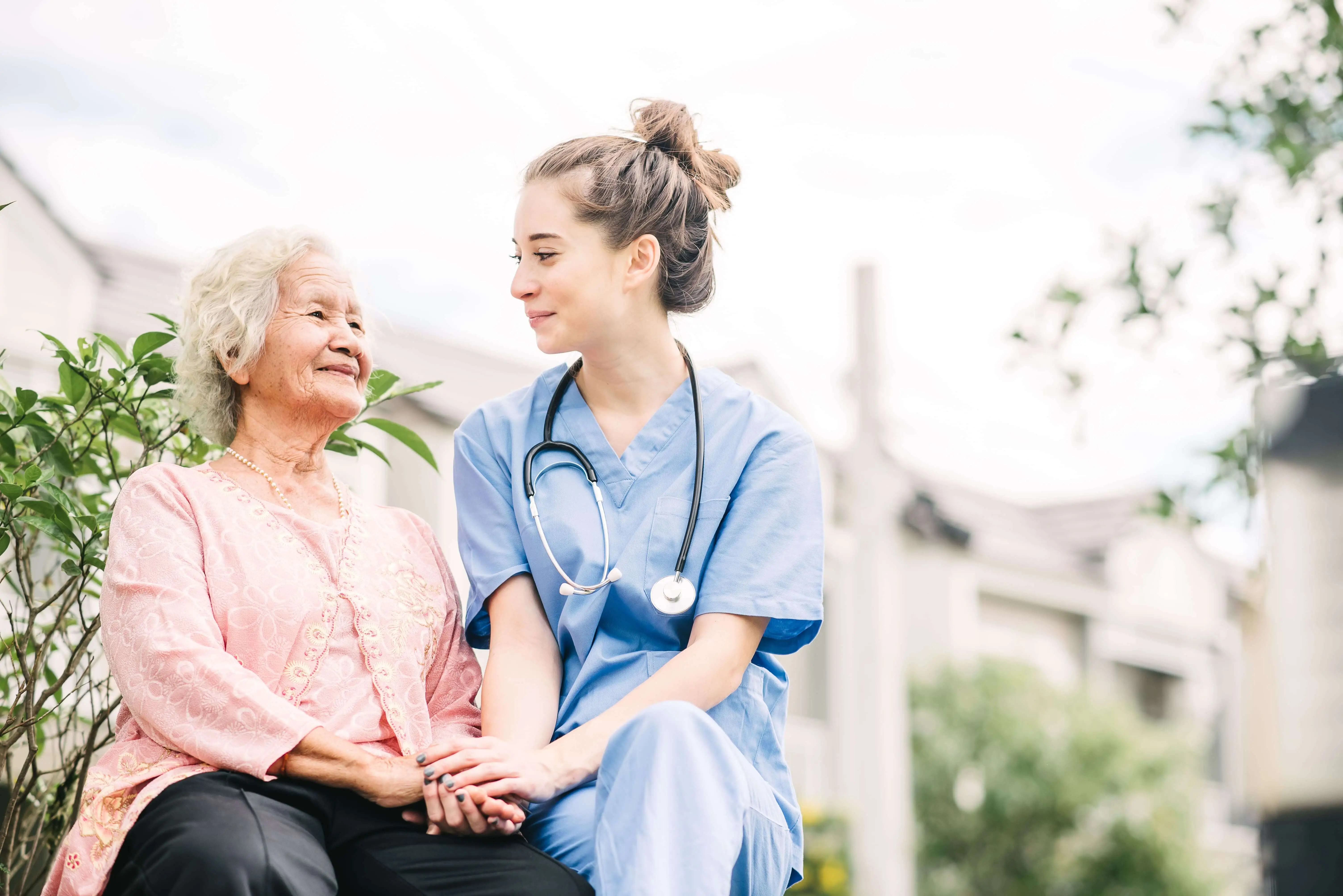 OC HomeCare nurse offering supportive and compassionate outdoor senior care to an elderly woman in Orange County, California