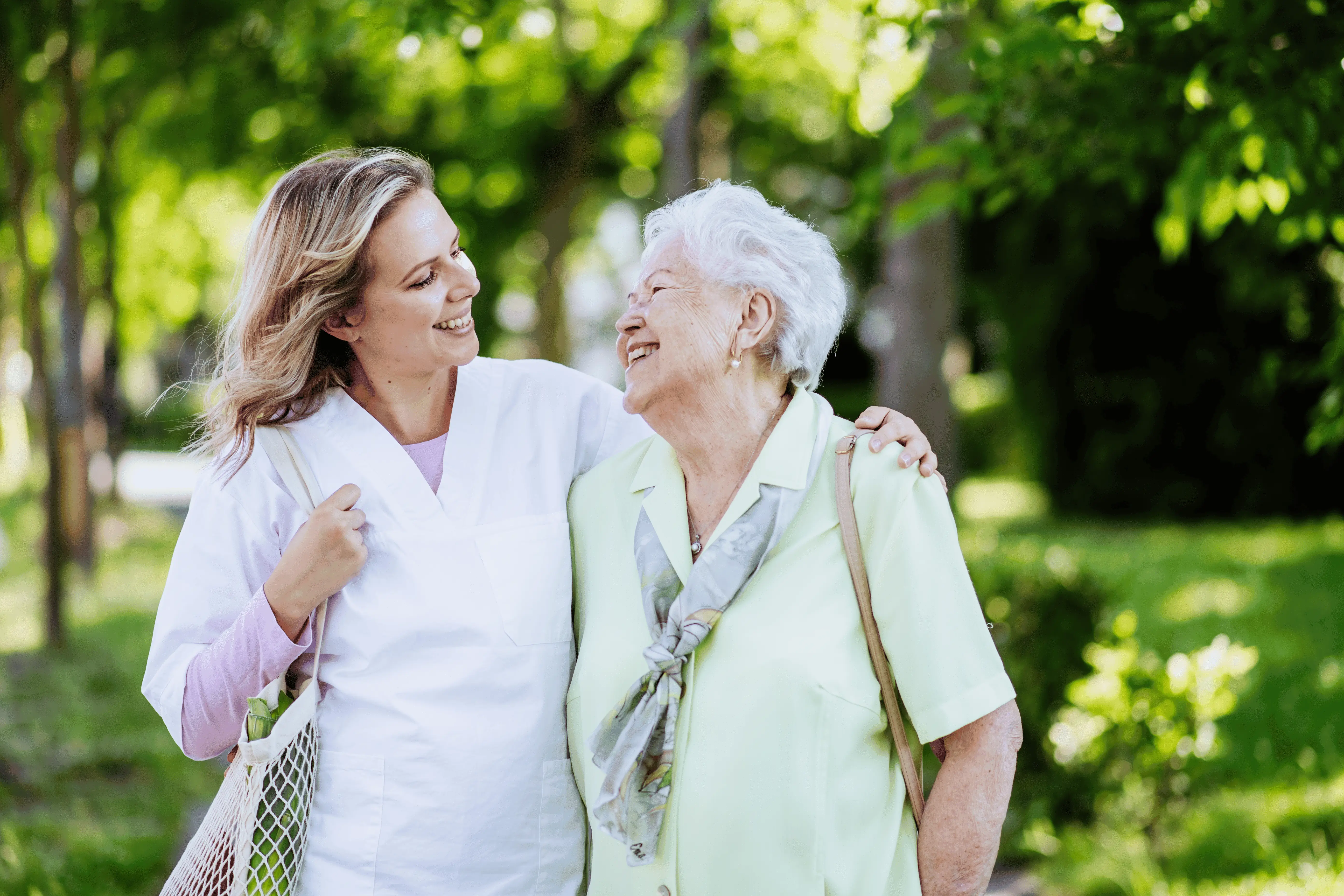 Smiling OC Homecare caregiver walking with senior client in Orange County, providing trusted and compassionate home care services