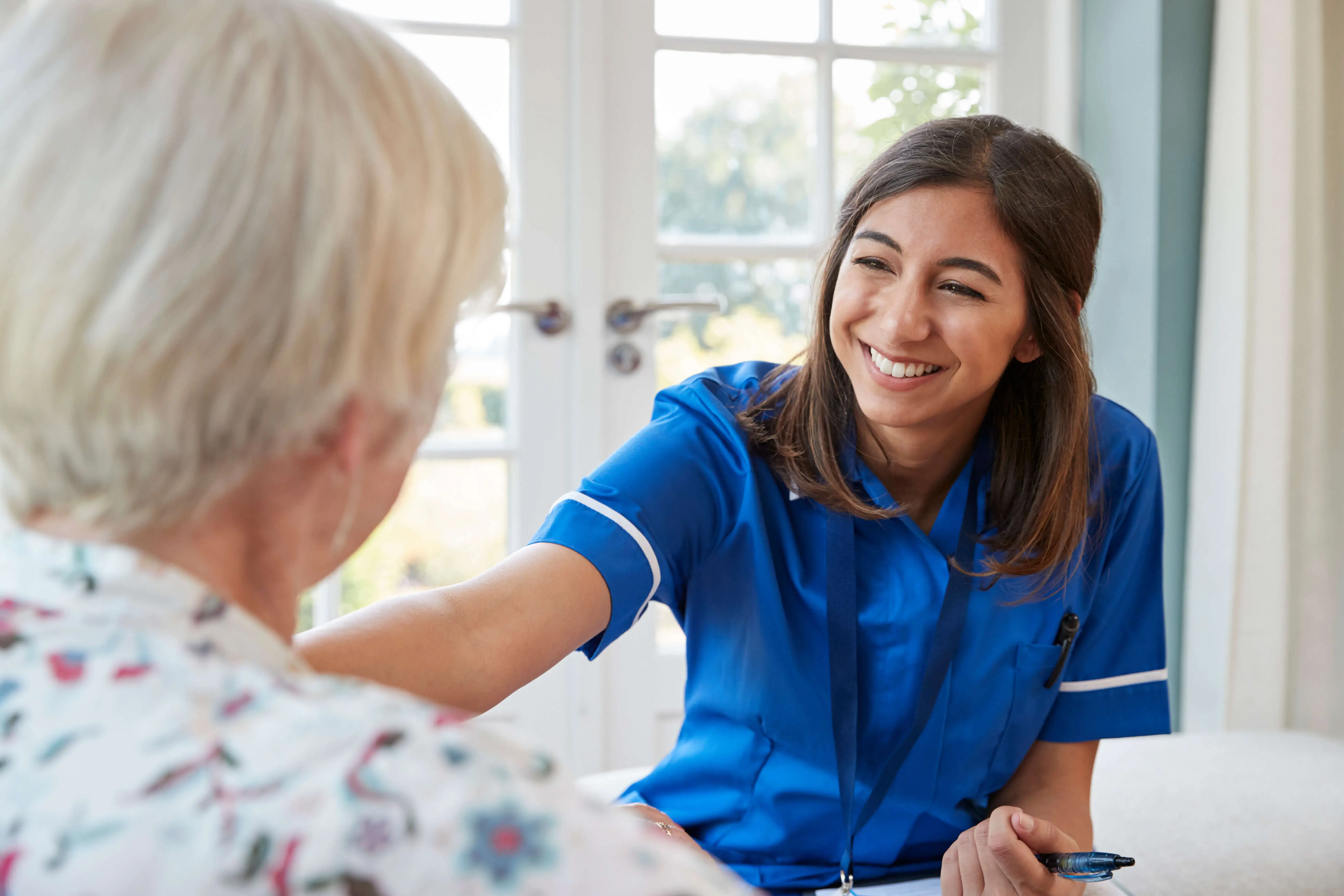 Smiling OC HomeCare caregiver delivering warm and personalized in-home senior care in Dana Point, California – Compassion and professionalism for your loved one